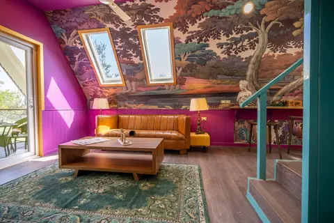Living room under a sloping ceiling lit by roof windows